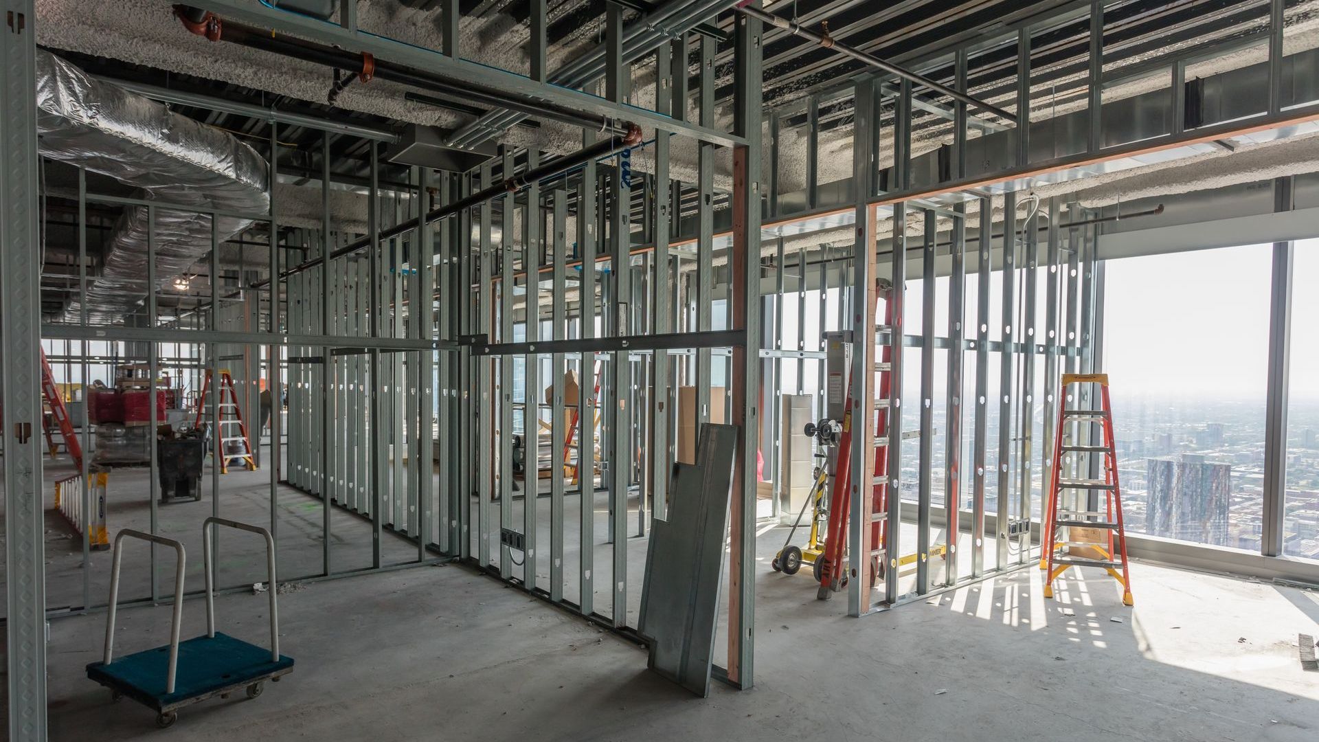 The inside of a building under construction with a lot of metal frames.