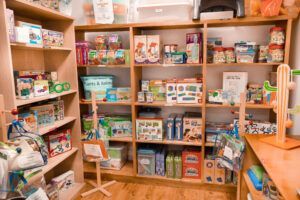Shelves in a brightly lit shop filled with toys, games, and gifts.