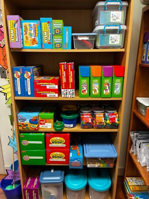 Shelves stocked with assorted colorful packaged goods and containers in a store or storage room