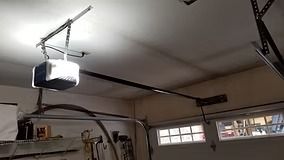 Garage ceiling with an electric garage door opener installed.
