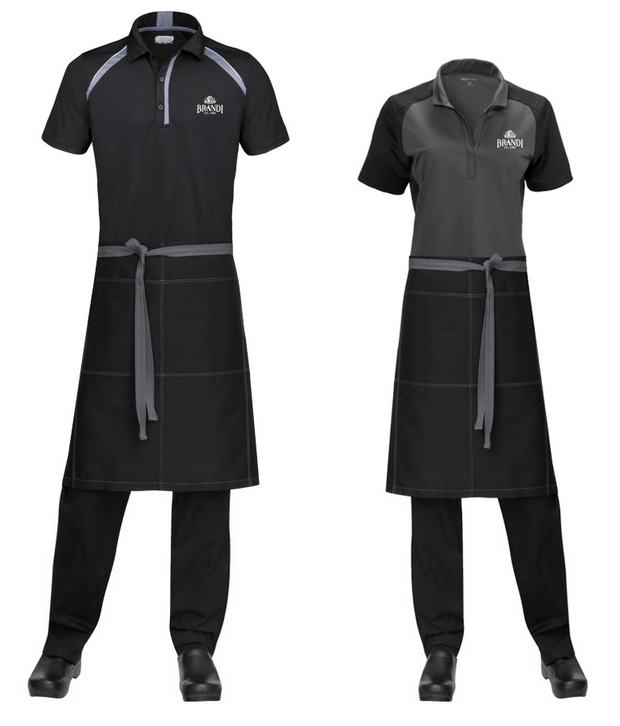 Two mannequins wearing black restaurant uniforms: collared shirt, apron, pants.