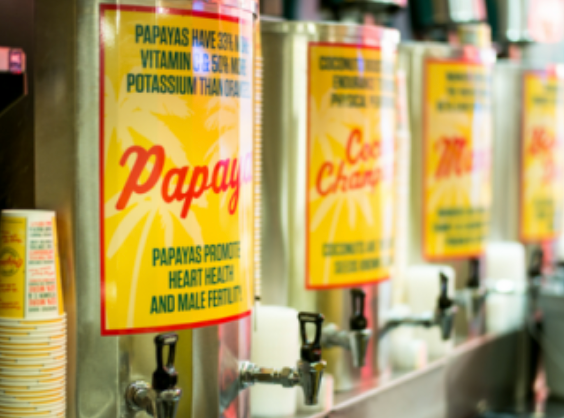 Beverage dispensers with colorful signs advertising 
