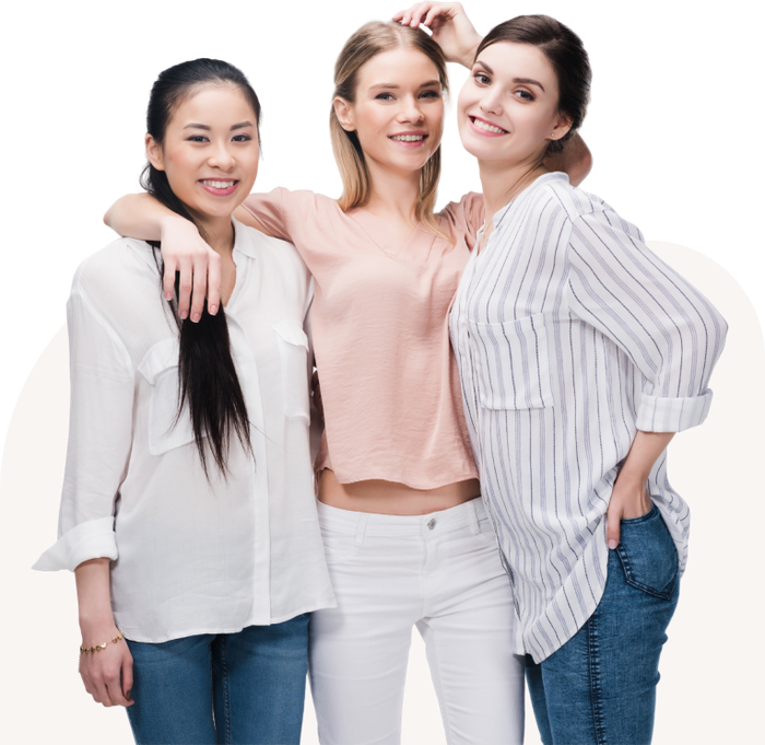 Three women are posing for a picture together and smiling