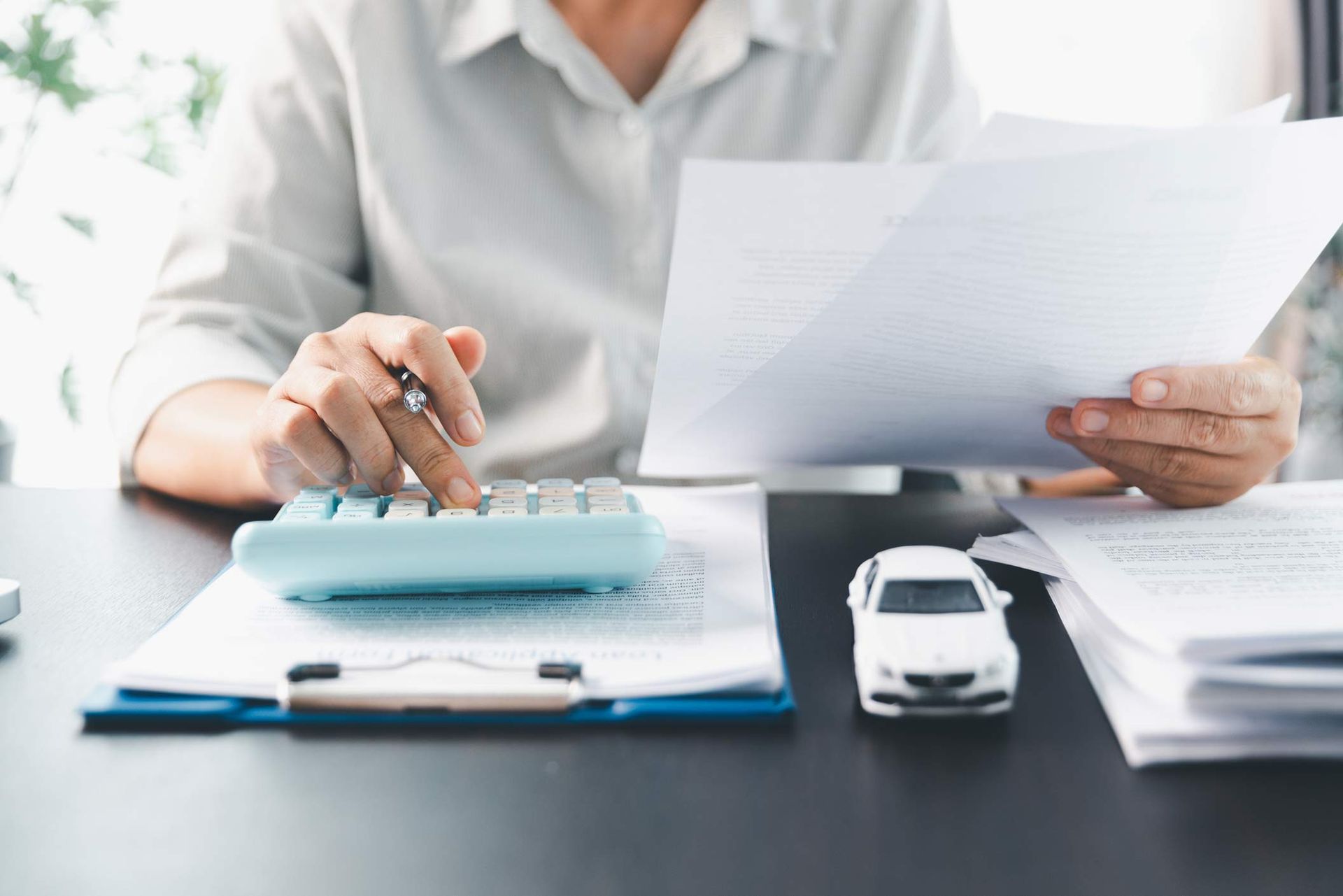 Car dealer businesswoman signing car insurance document or lease paper. Car dealer businesswoman signing car insurance document or lease paper.