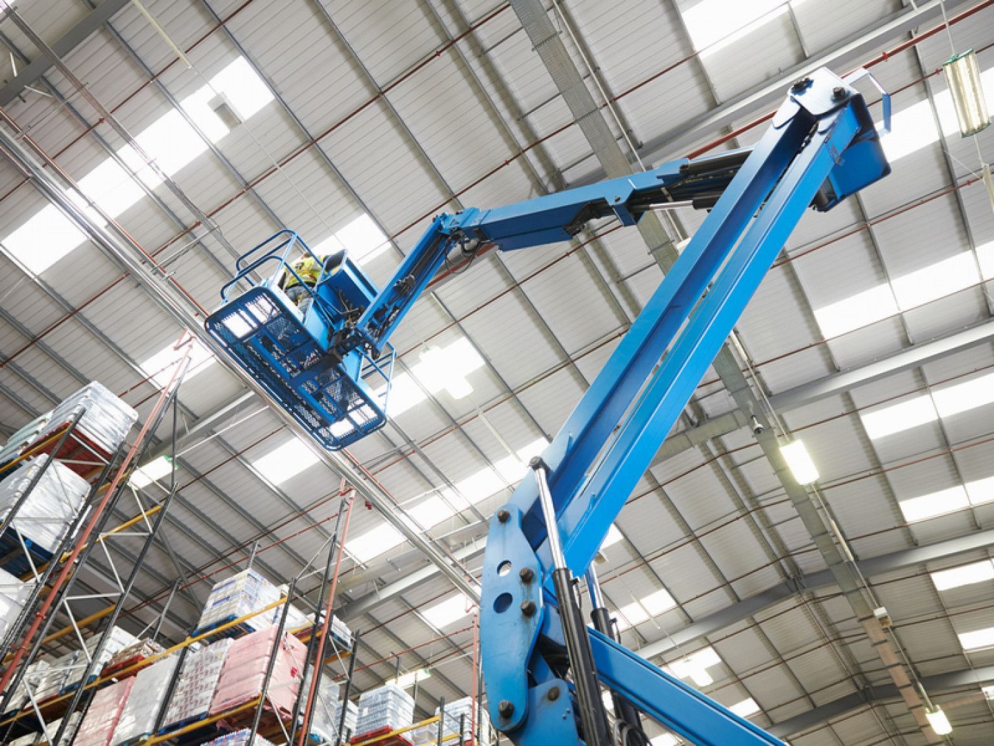 Man Working on A Lift in A Warehouse