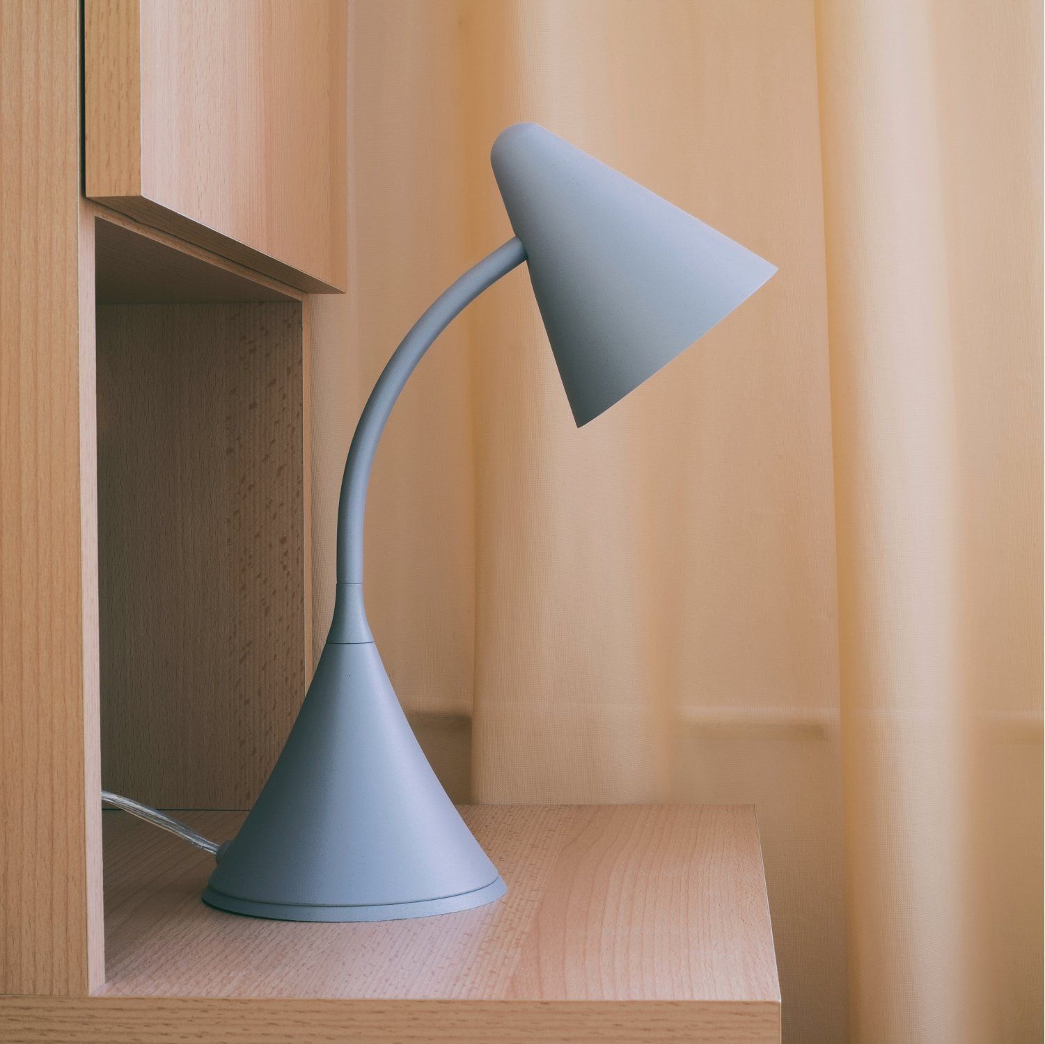 Blue desk lamp with a conical base and shade, curved arm.
