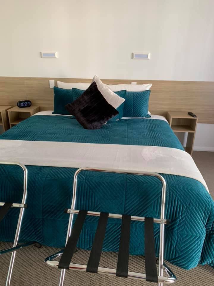 Bed With Dark Cyan And White Bed Sheets — Merriwa Motor Inn & Motel In Merriwa NSW