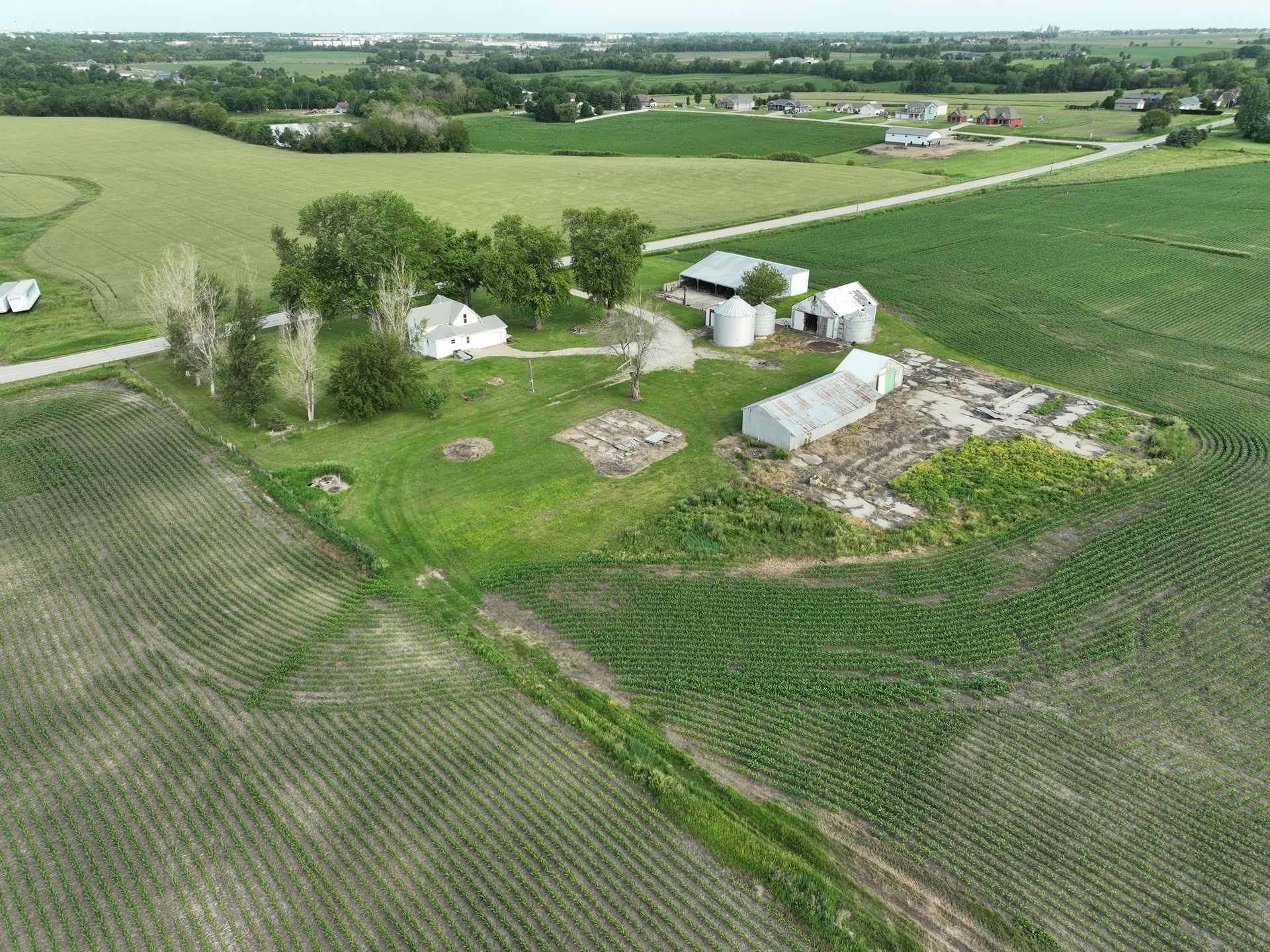 An aerial view of a farm in the middle of a field