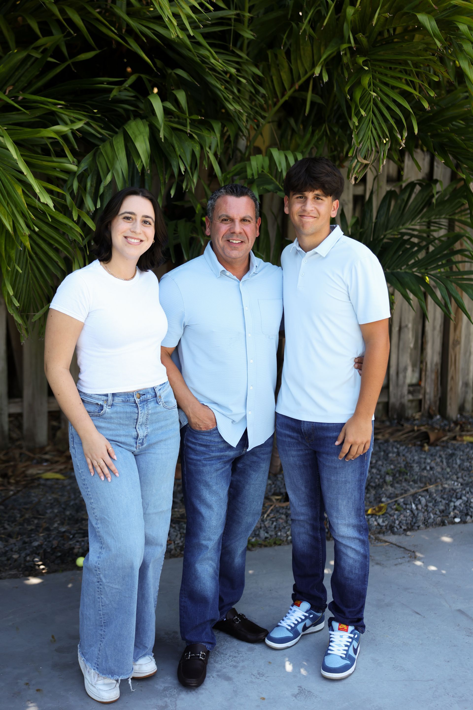 A man and two children are posing for a picture.