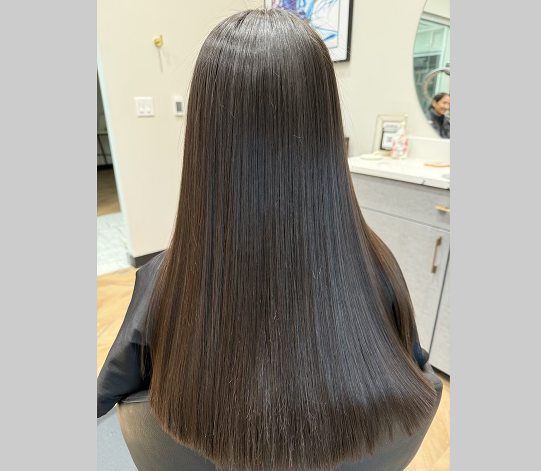 After picture of a woman and her hair is now soft and straight and shiny.