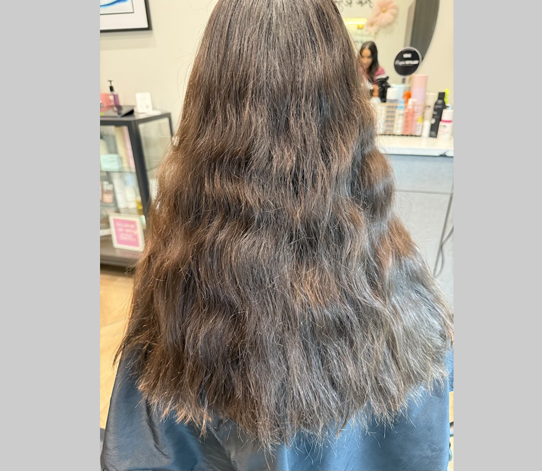 Before picture of a woman's hair that is very frizzy and kinky.