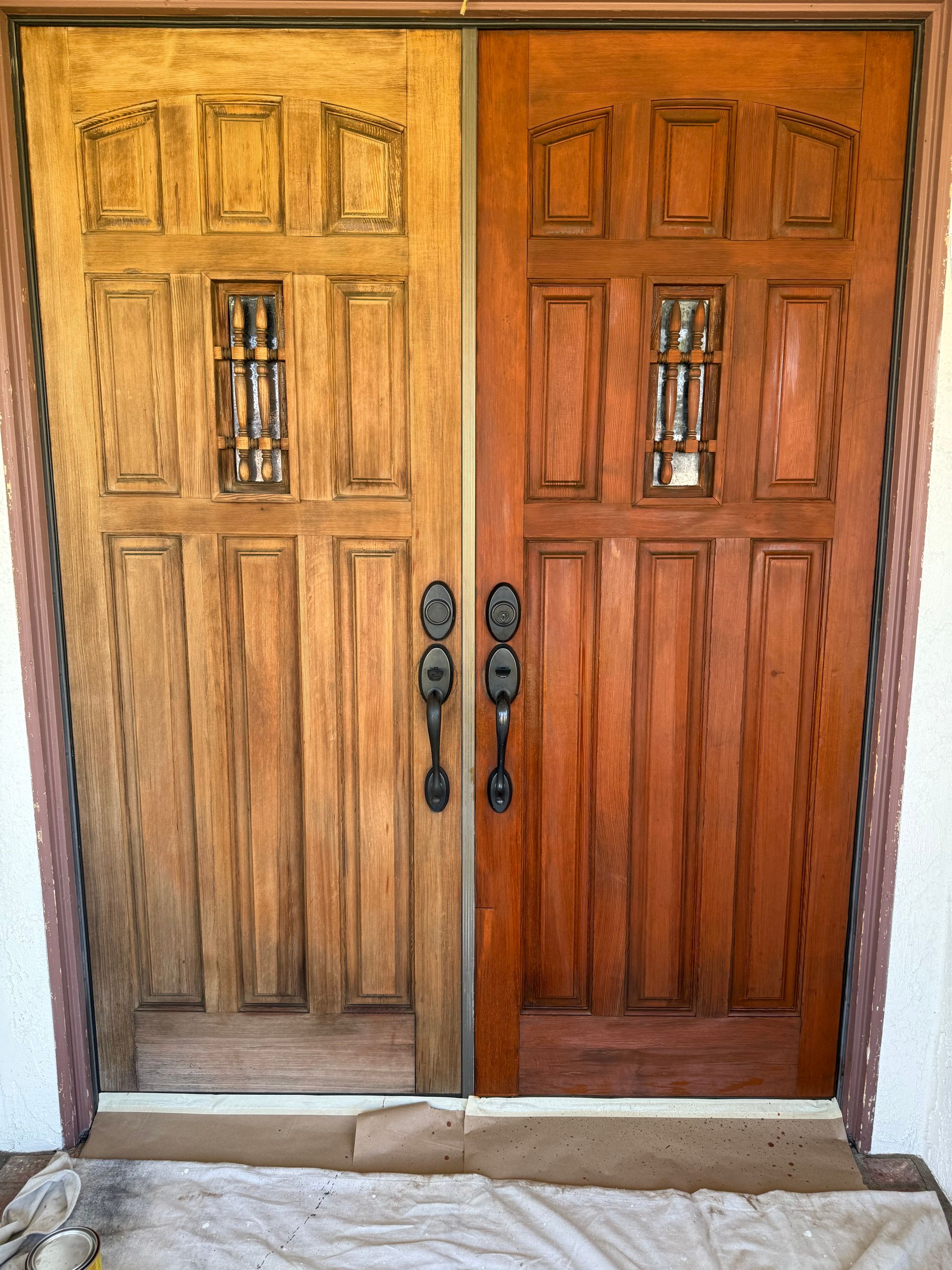 A corner of a room with a wooden floor and a door.