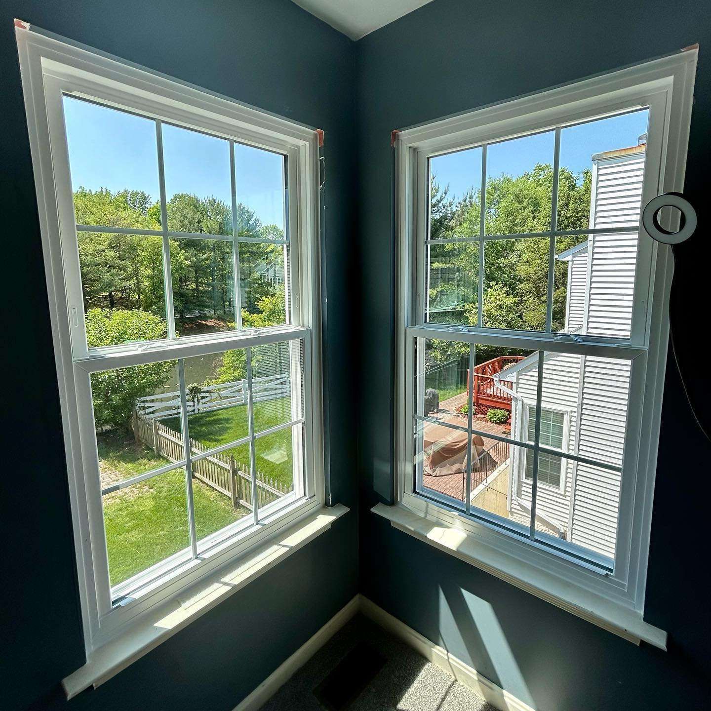A man is fixing a window with a screwdriver.