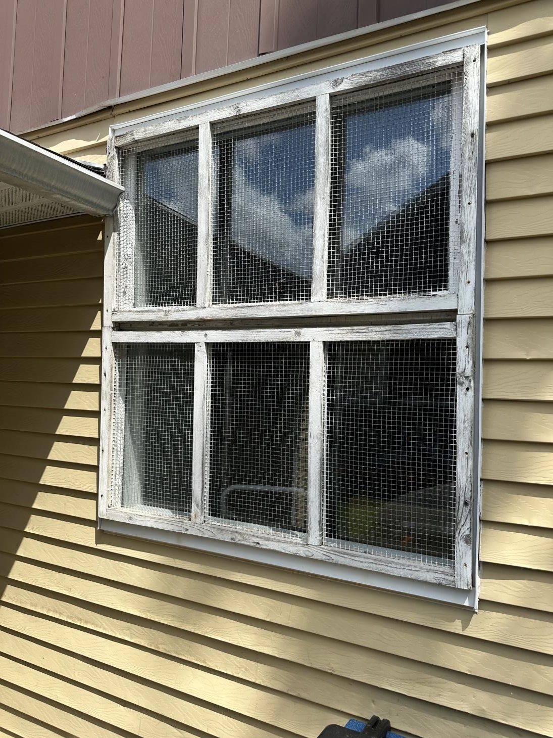 A man is installing a window in a house.