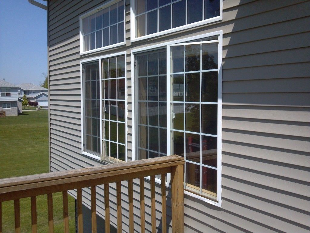 A man is fixing a window with a screwdriver.