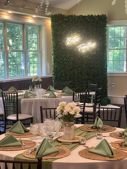 A room with tables and chairs set up for a wedding reception.