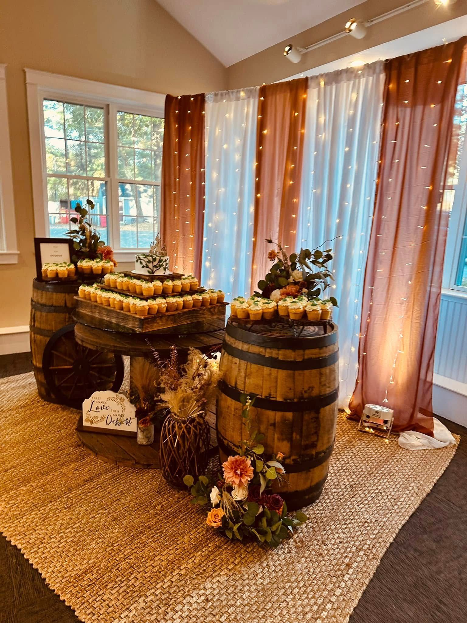 A room decorated with barrels and candles for a wedding reception.