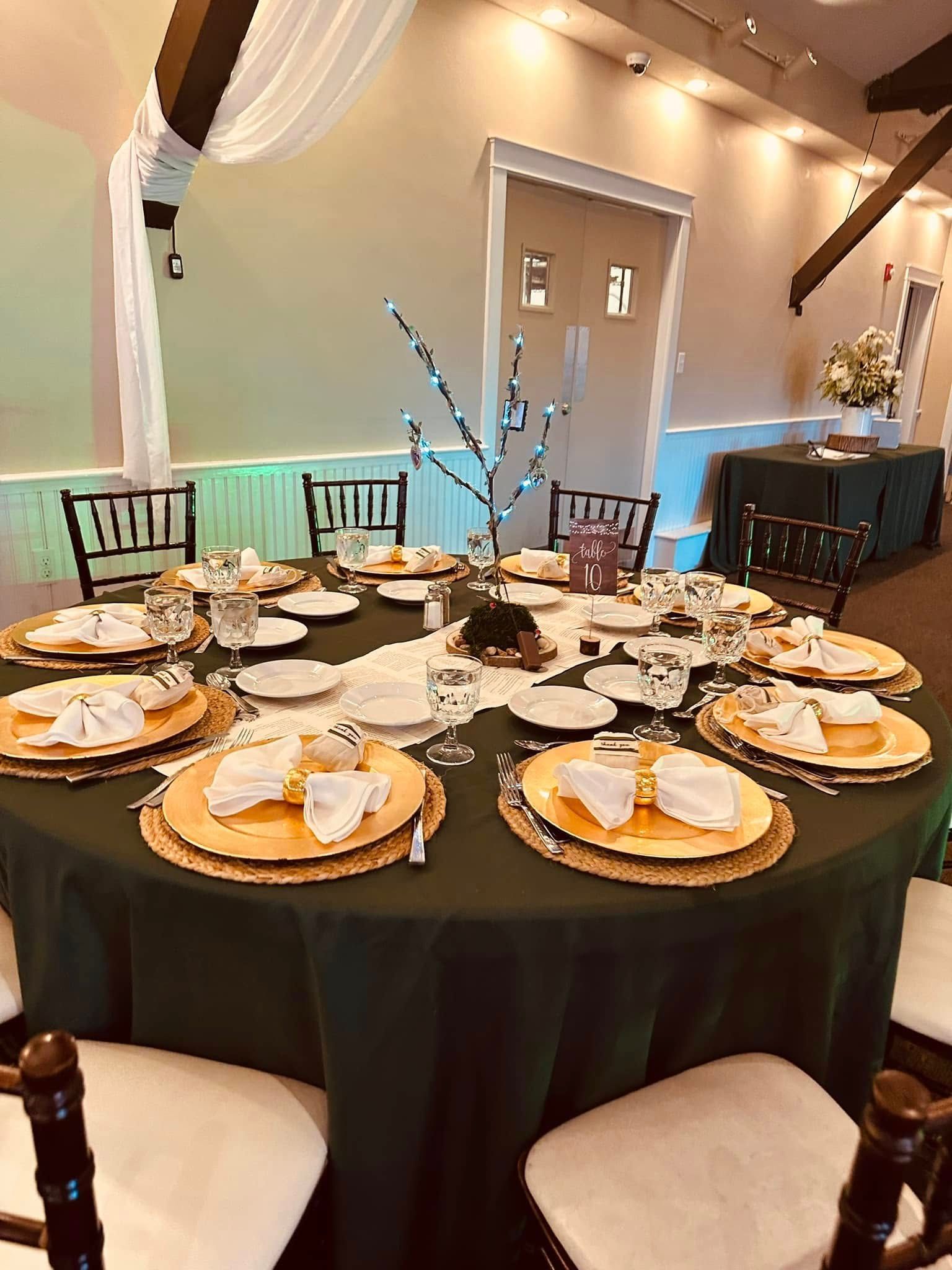 A table set for a wedding reception with plates and napkins on it.