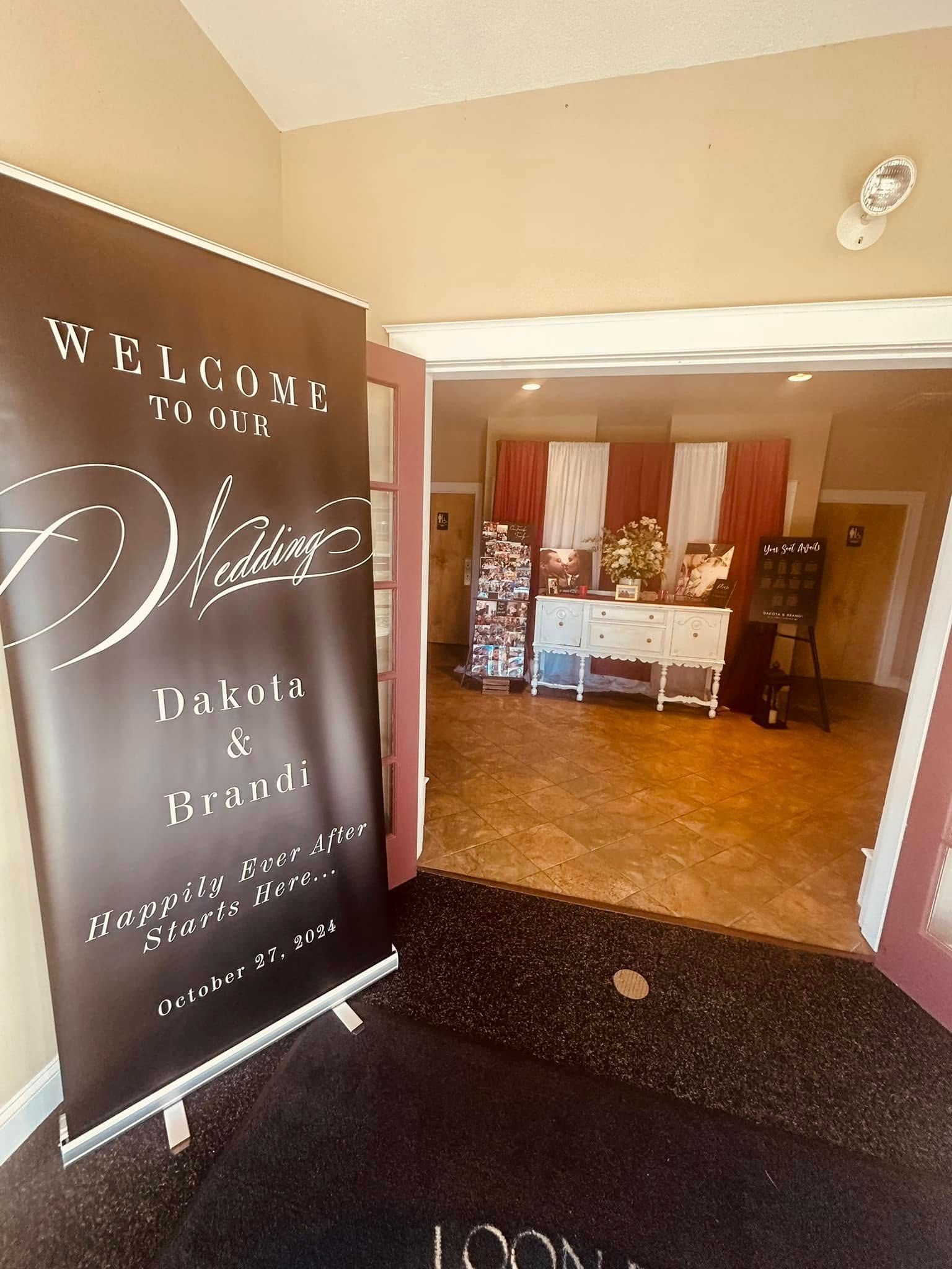 A welcome sign is hanging in a room next to a door.