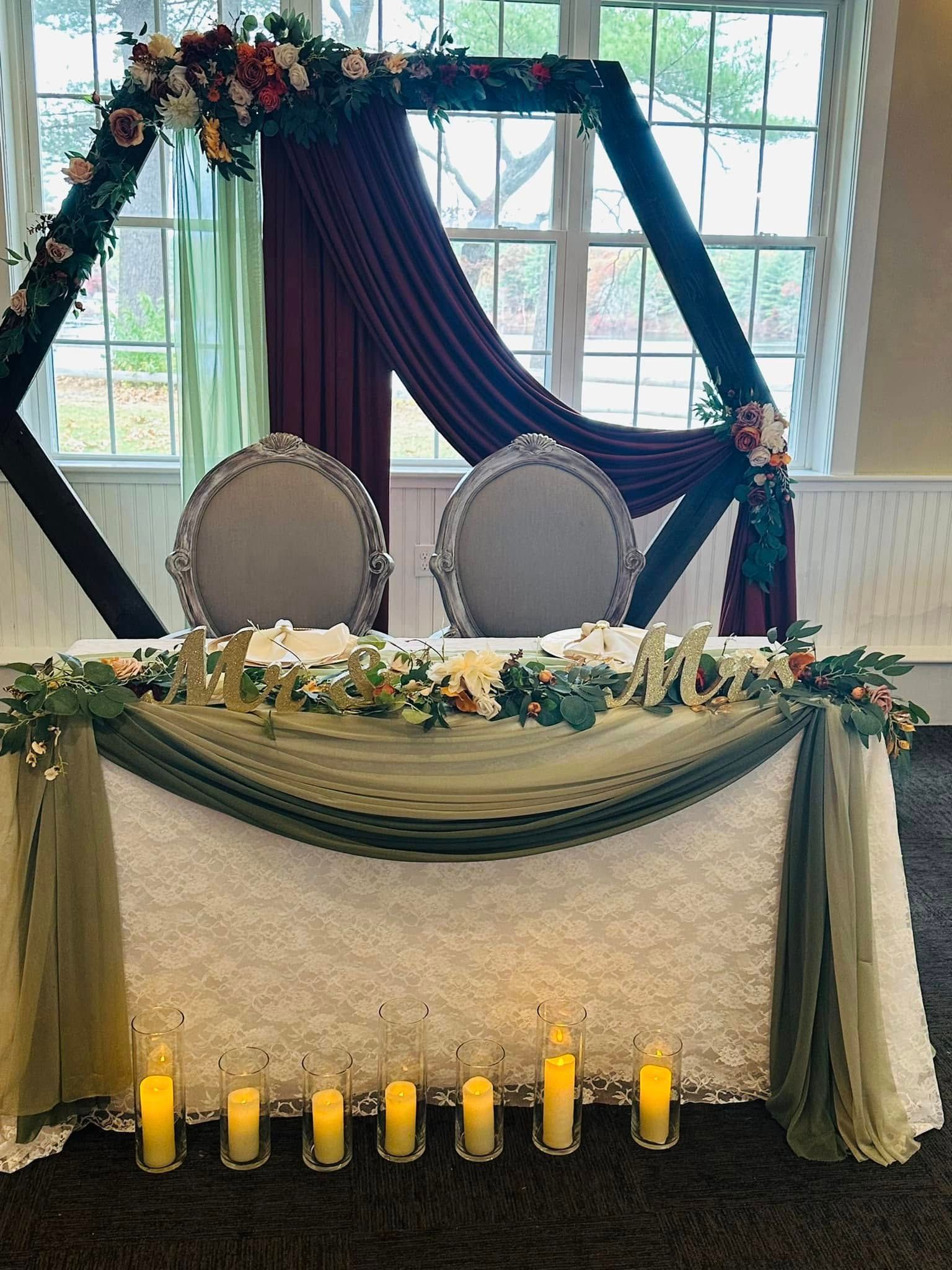 A table with candles and flowers on it in a room.
