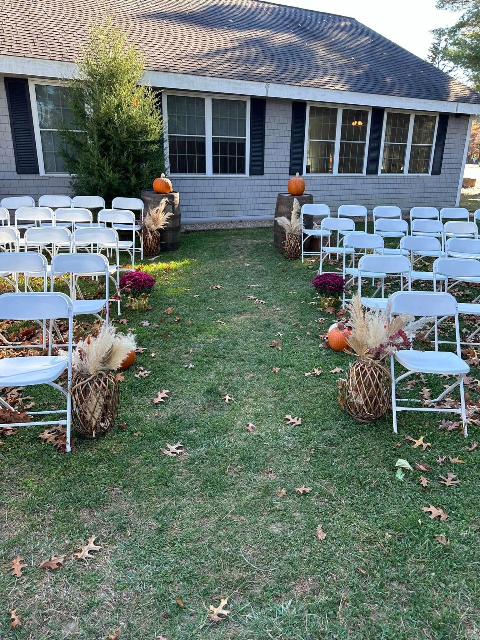 A wedding ceremony is taking place in front of a house.