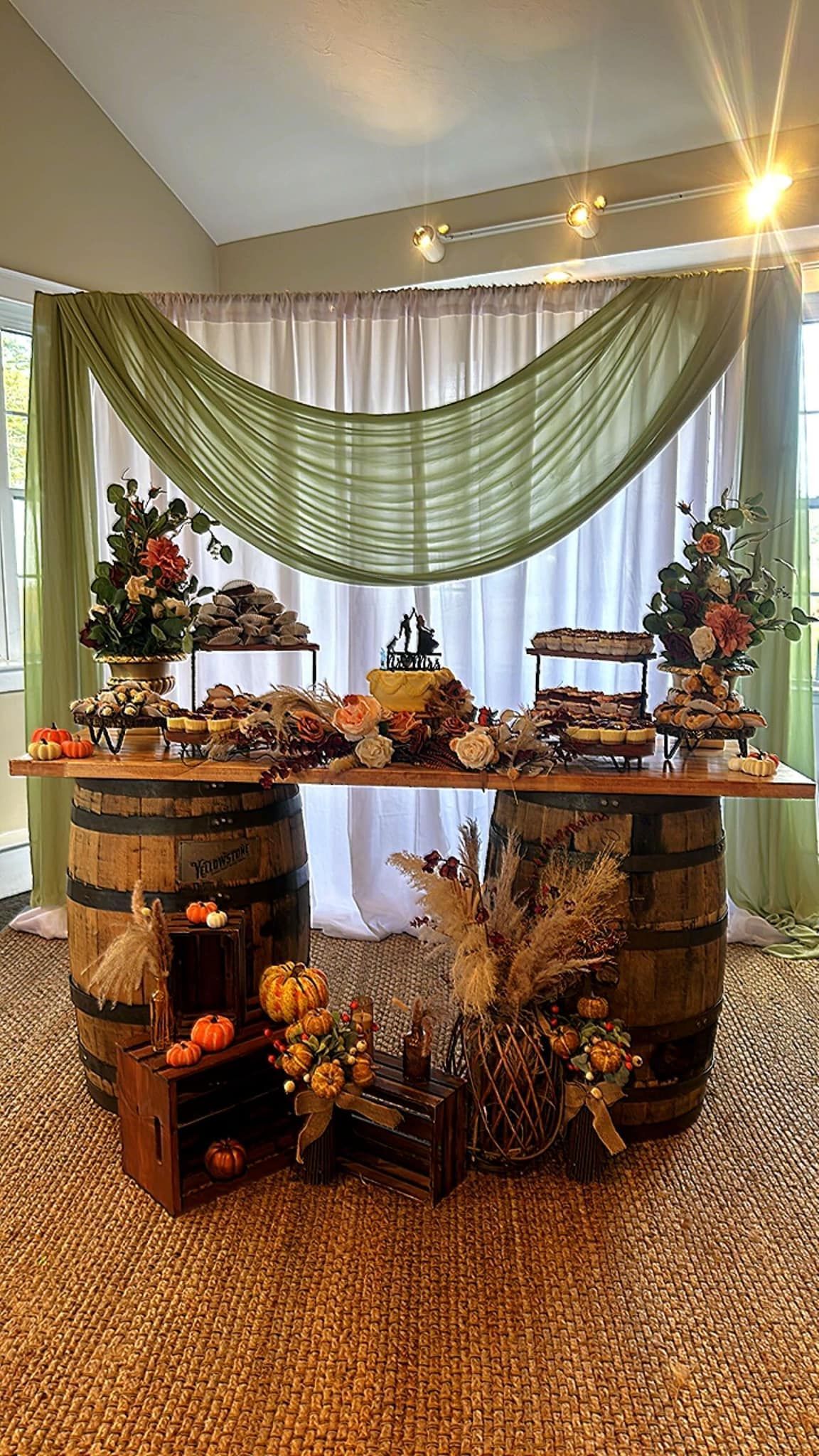 A table with barrels and flowers on it in a room.