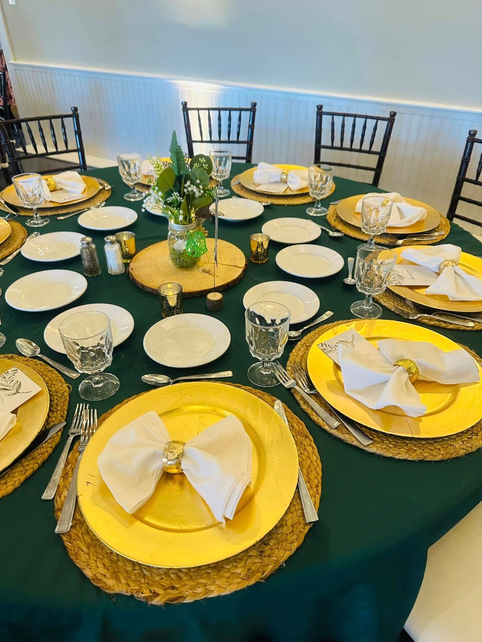 A table set for a dinner party with plates , utensils , and napkins.