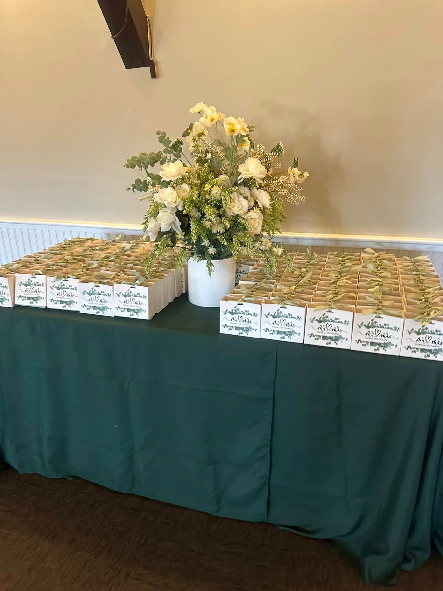 A table with a vase of flowers on top of it.