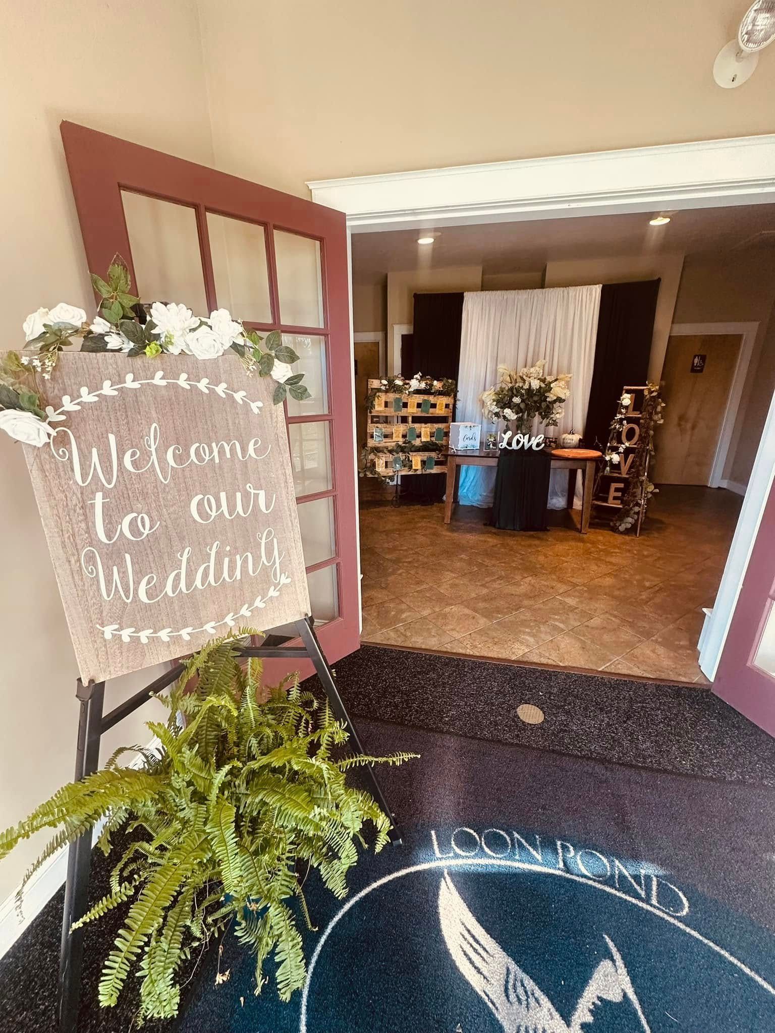 A welcome sign is hanging from a door in a room.