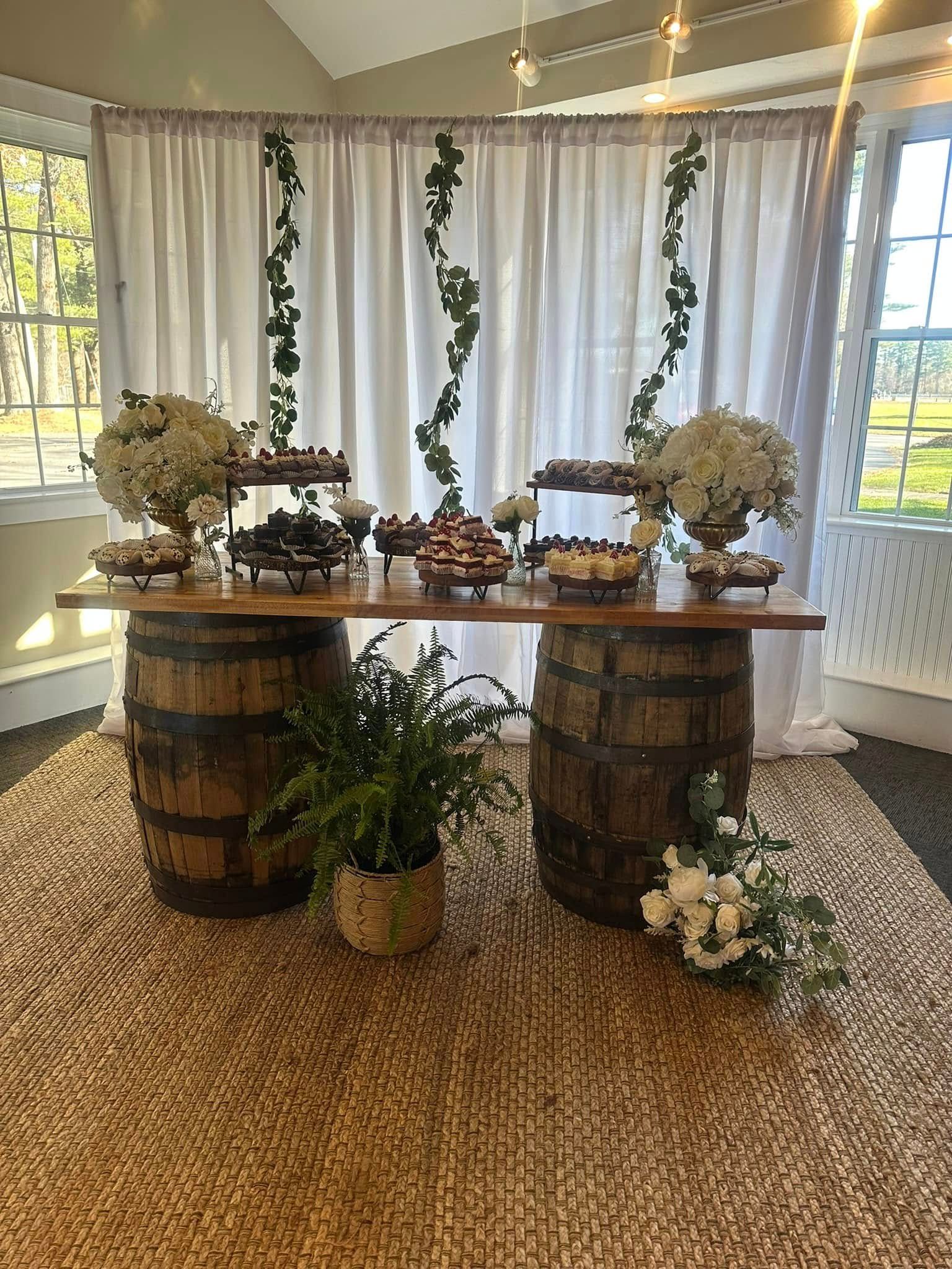 A table with barrels and flowers on it in a room.