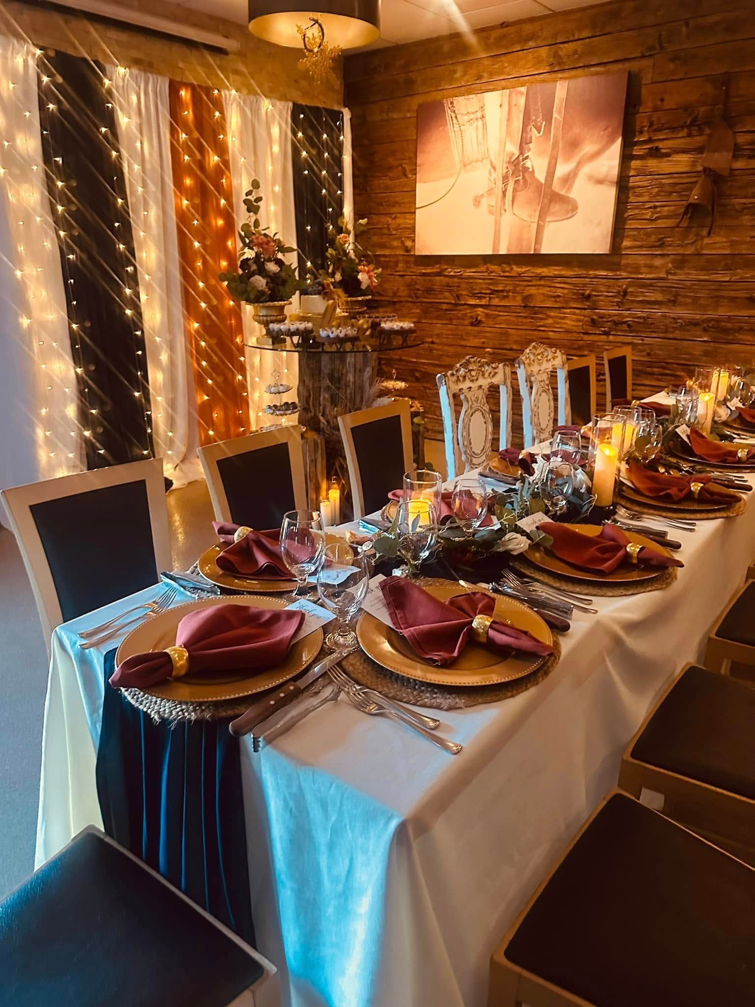 A long table with plates and napkins on it in a room.