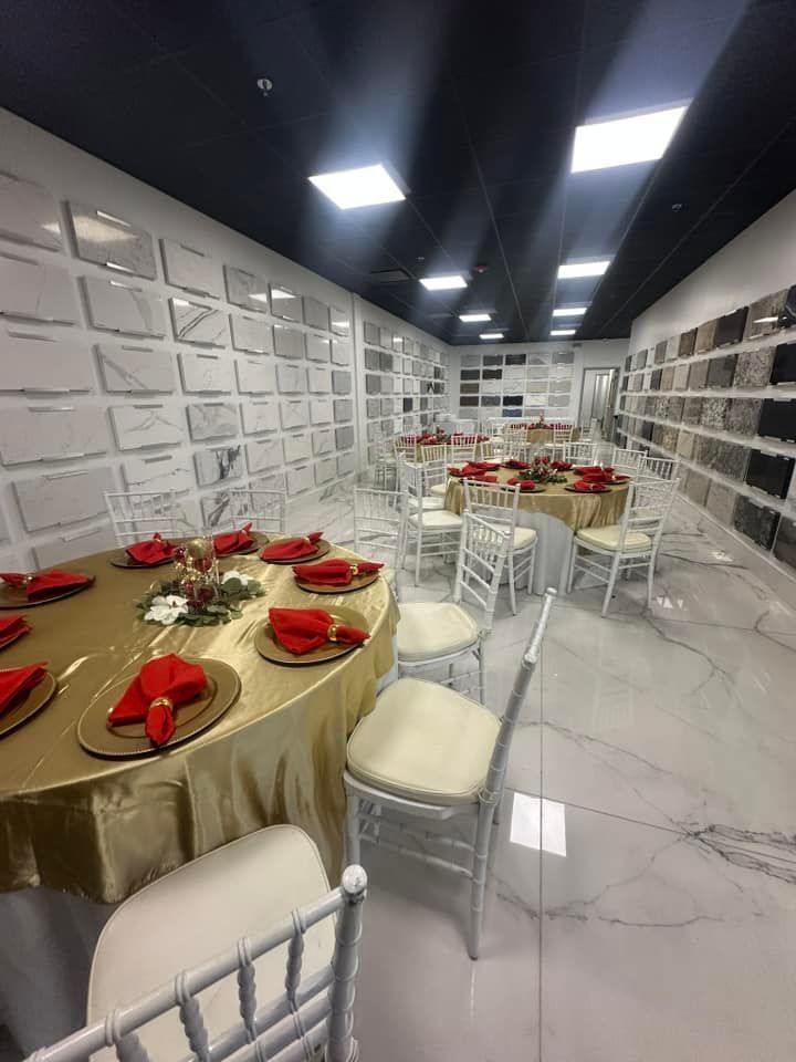 A room with tables and chairs set up for a party.