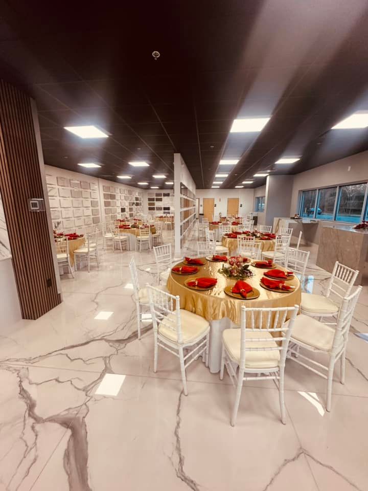 A large room with tables and chairs set up for a party.