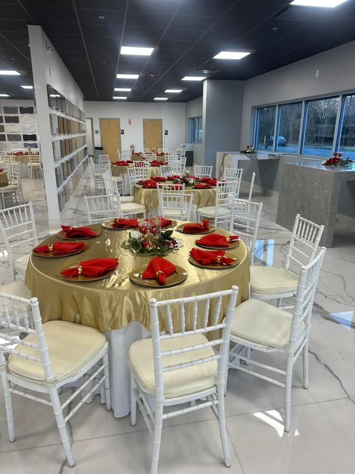 A large room with tables and chairs set up for a party.