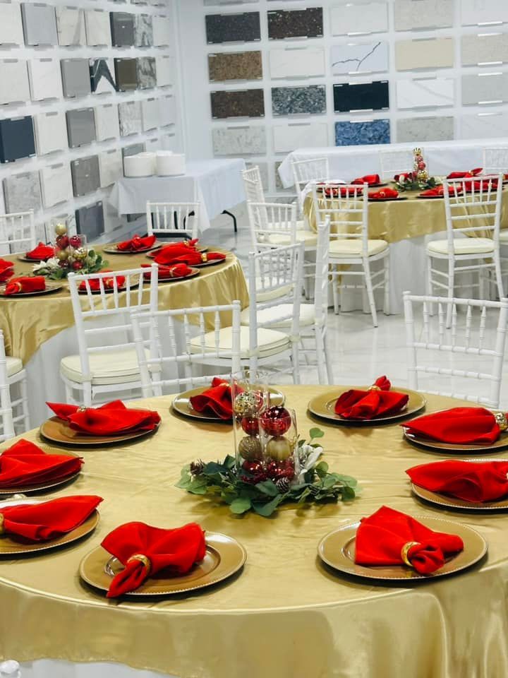 A room filled with tables and chairs decorated for a christmas party.