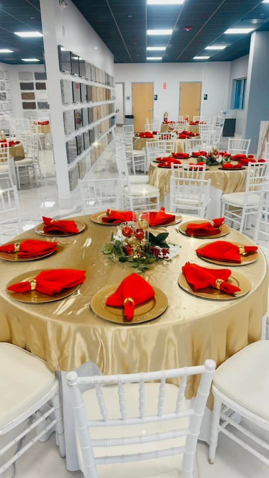 A large room with tables and chairs set up for a party.