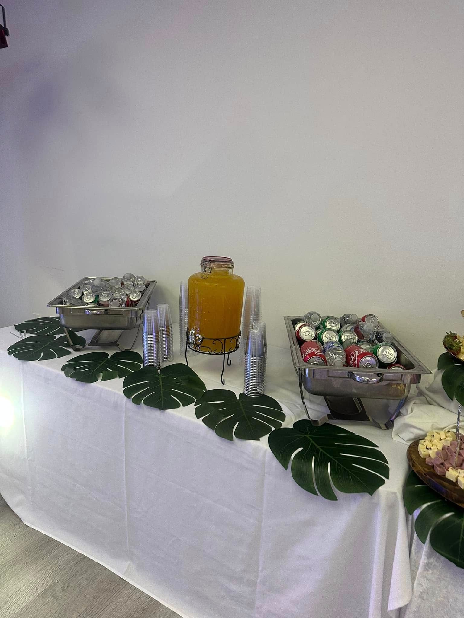 A table with a variety of food and drinks on it.