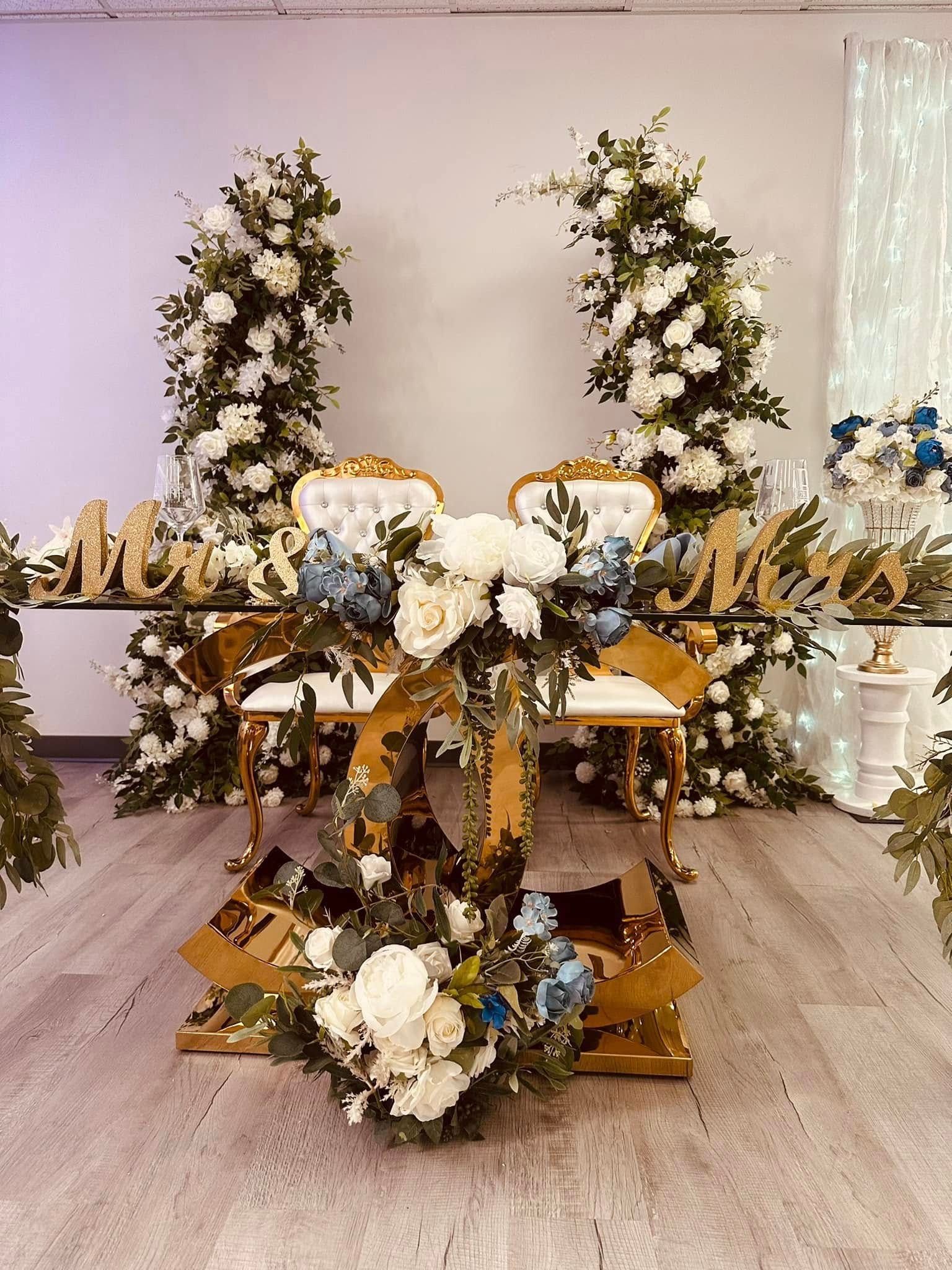 A table and chairs decorated with flowers in a room.