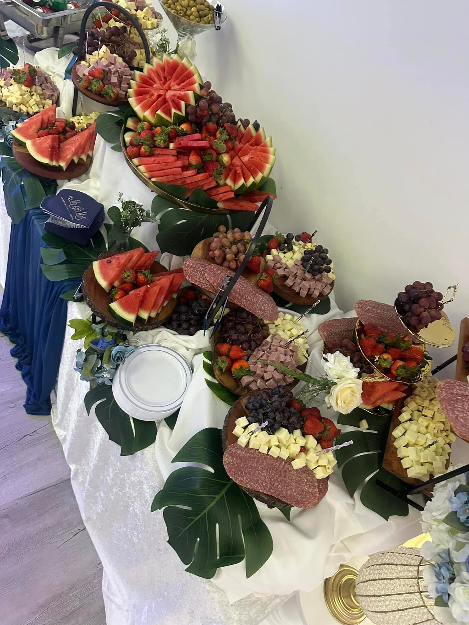 A long table topped with a variety of fruits and vegetables.