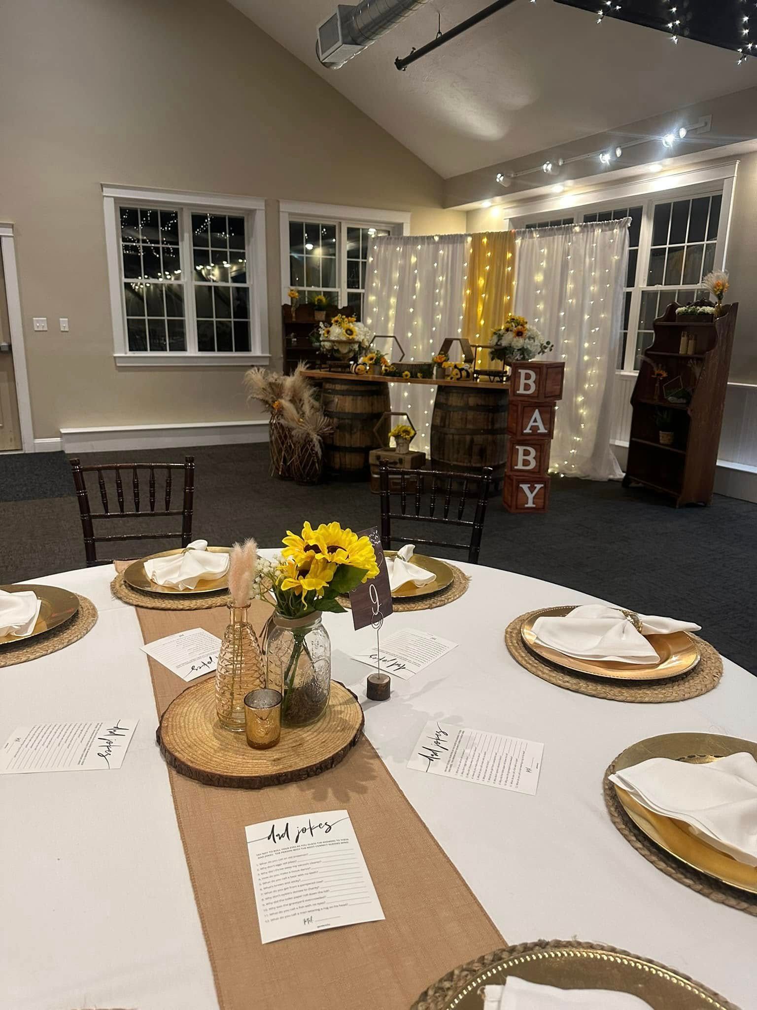 A table set up for a baby shower with plates , napkins , and flowers.