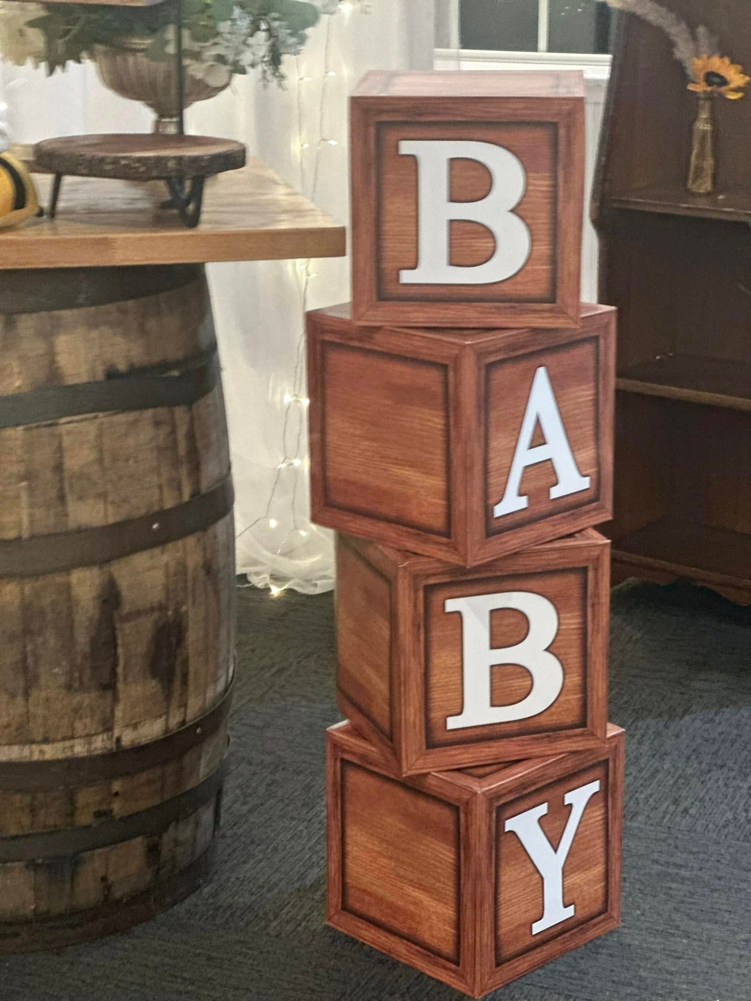 A stack of wooden baby blocks sitting next to a wooden barrel.