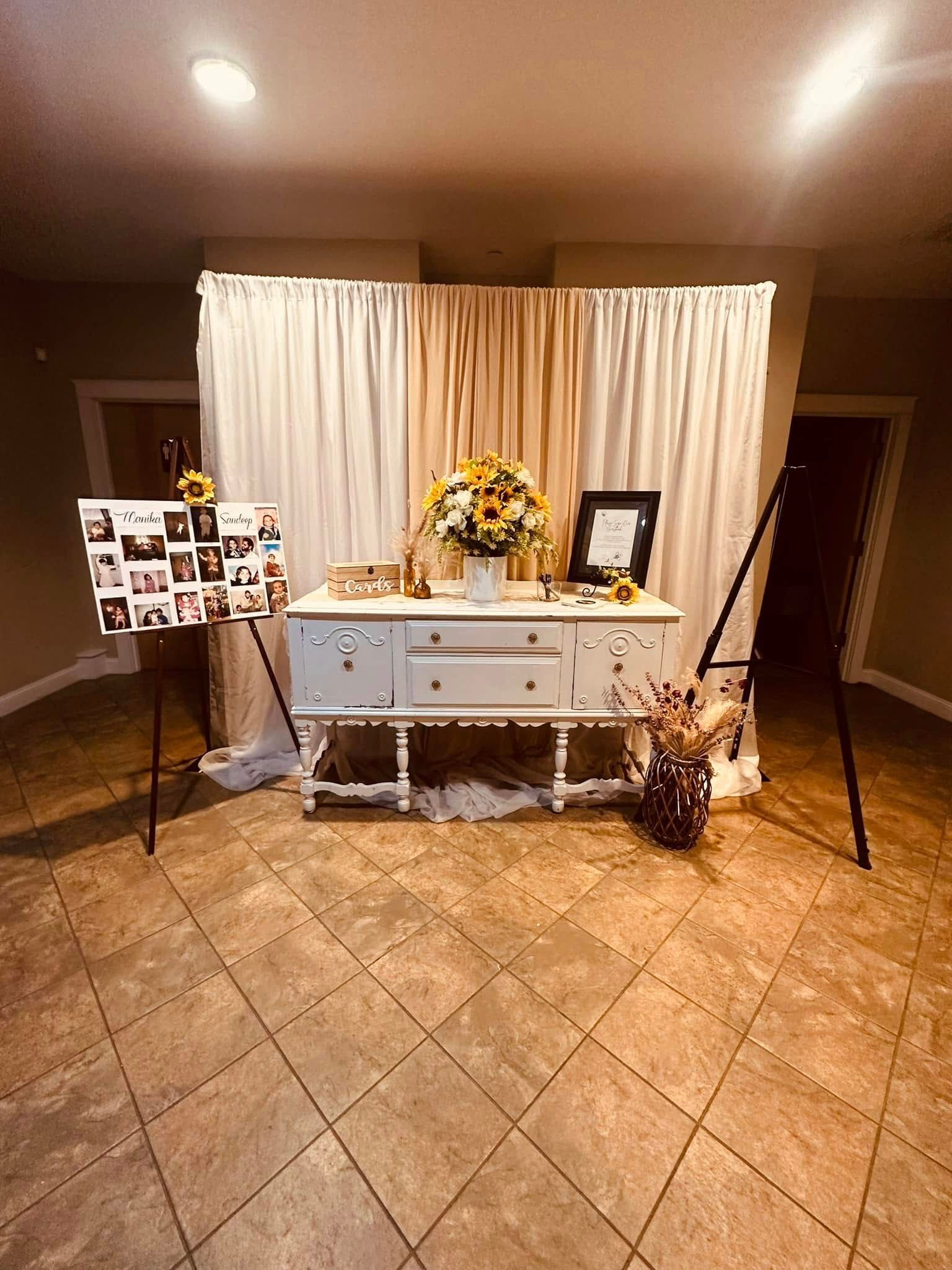 There is a table with flowers on it in the middle of the room.