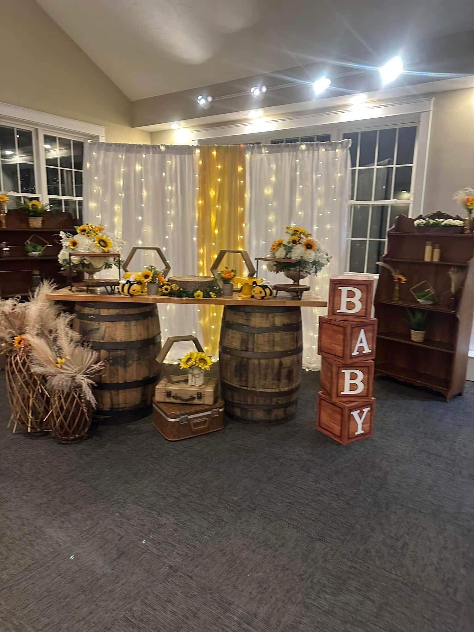 A room decorated for a baby shower with wooden barrels and wooden blocks.