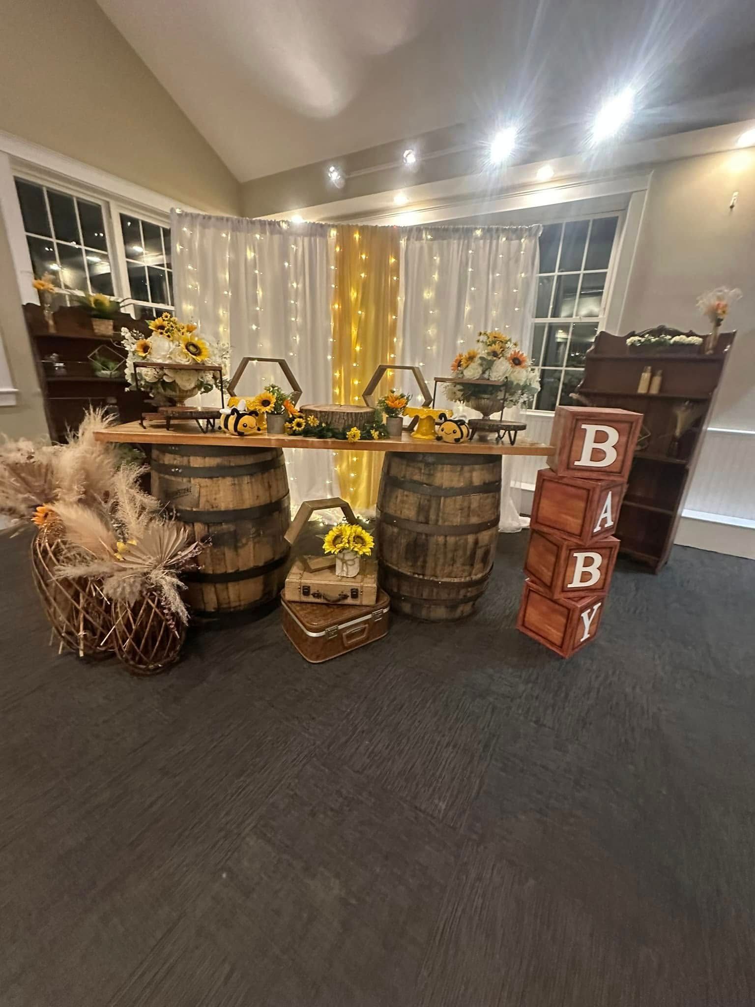 A room decorated for a baby shower with barrels , flowers , and blocks.
