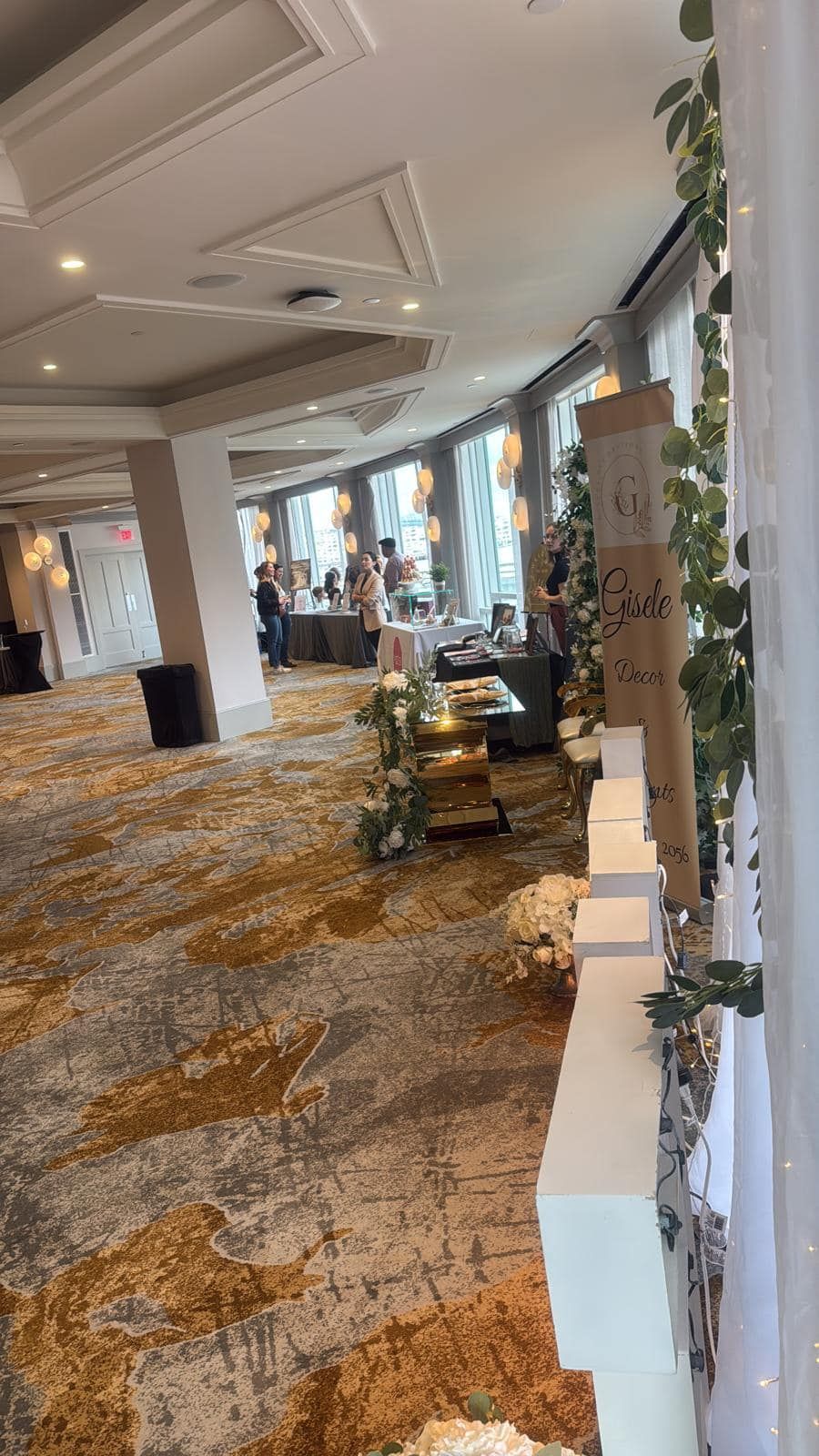 A large room with a lot of windows and a carpeted floor.