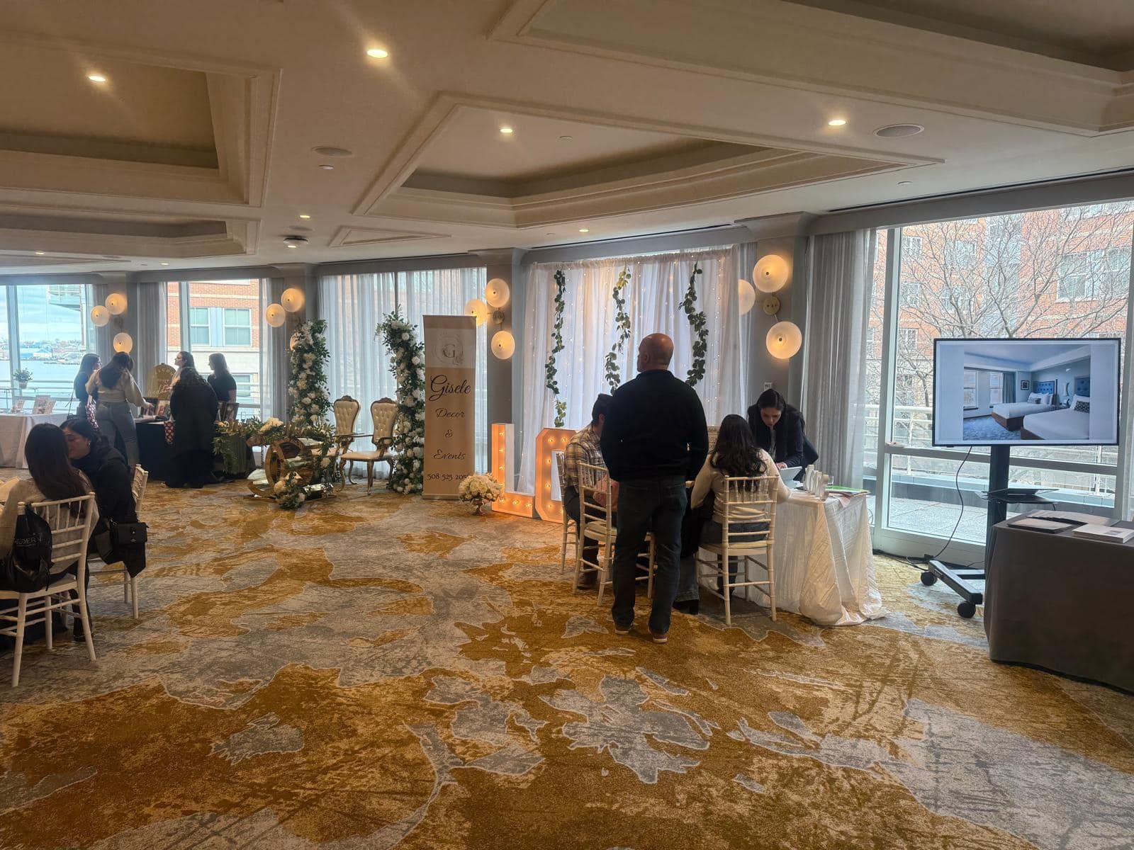 A group of people are standing around a table in a large room.