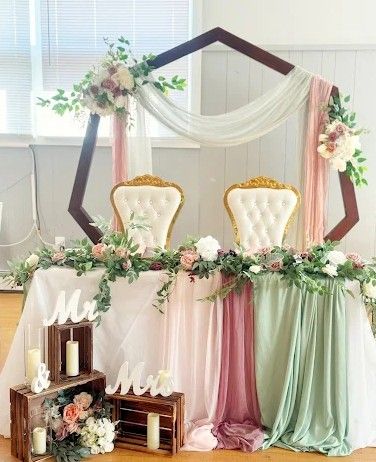 A large room with tables and chairs set up for a wedding reception.