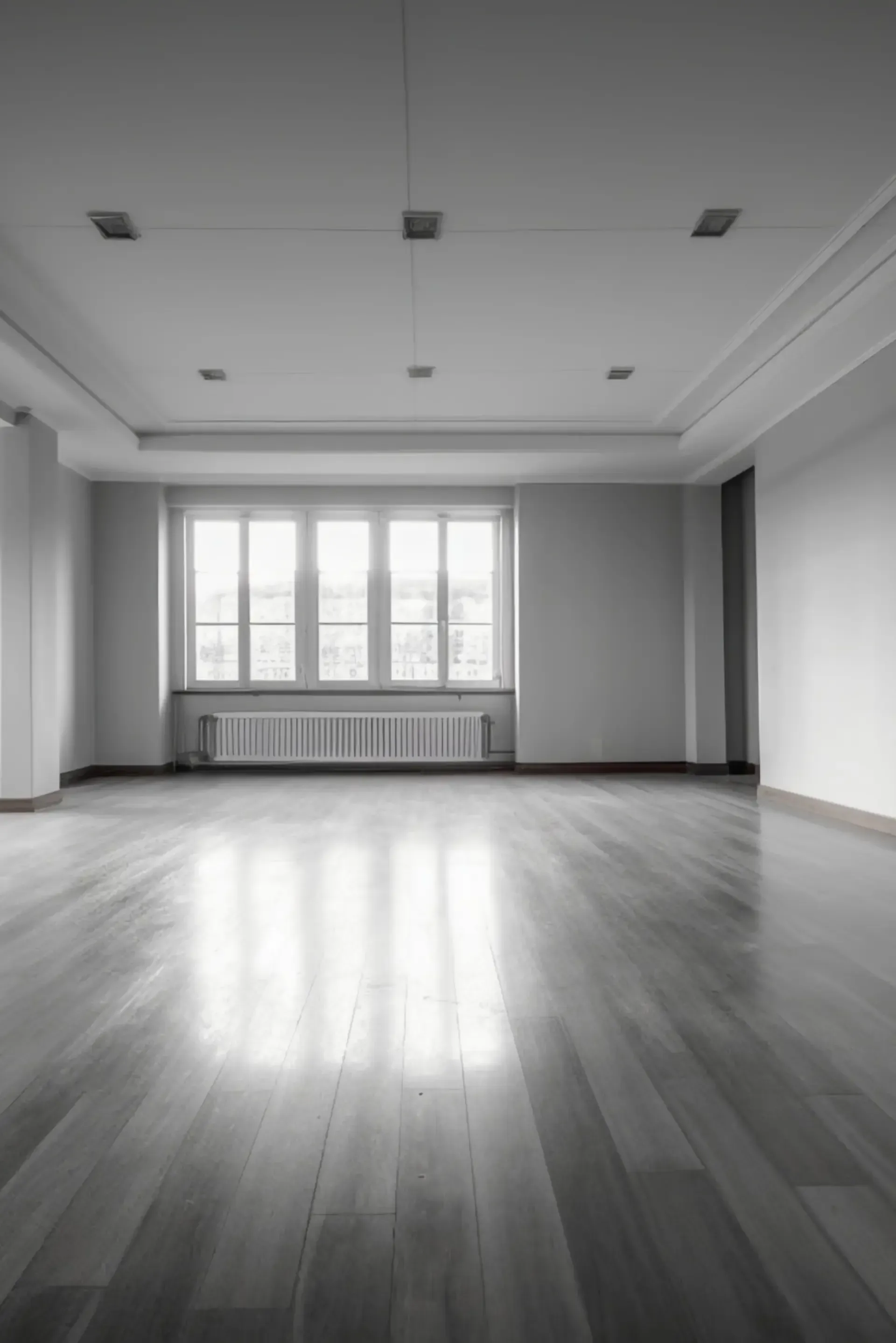 Spacious-+empty+room+with+wooden+flooring-+large+windows-+and+neutral-colored+walls-+well-lit-+minimalist+design.webp