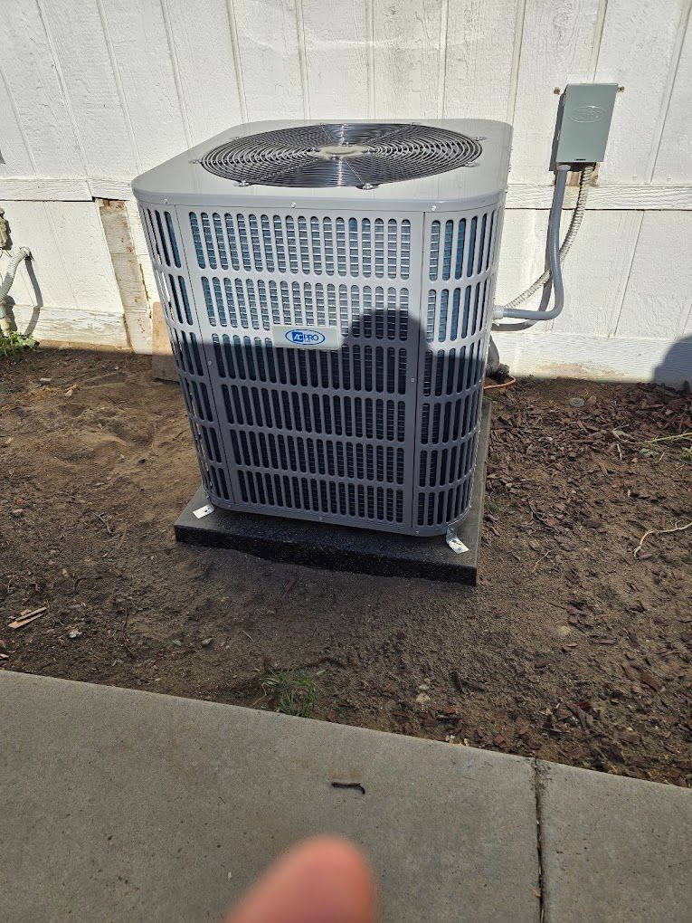 new  air conditioner is sitting on the side of a house.