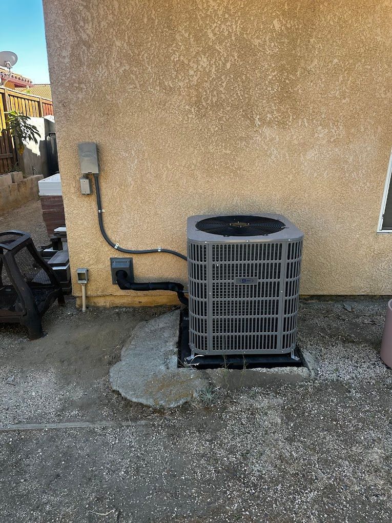 new  air conditioner is sitting on the side of a house.